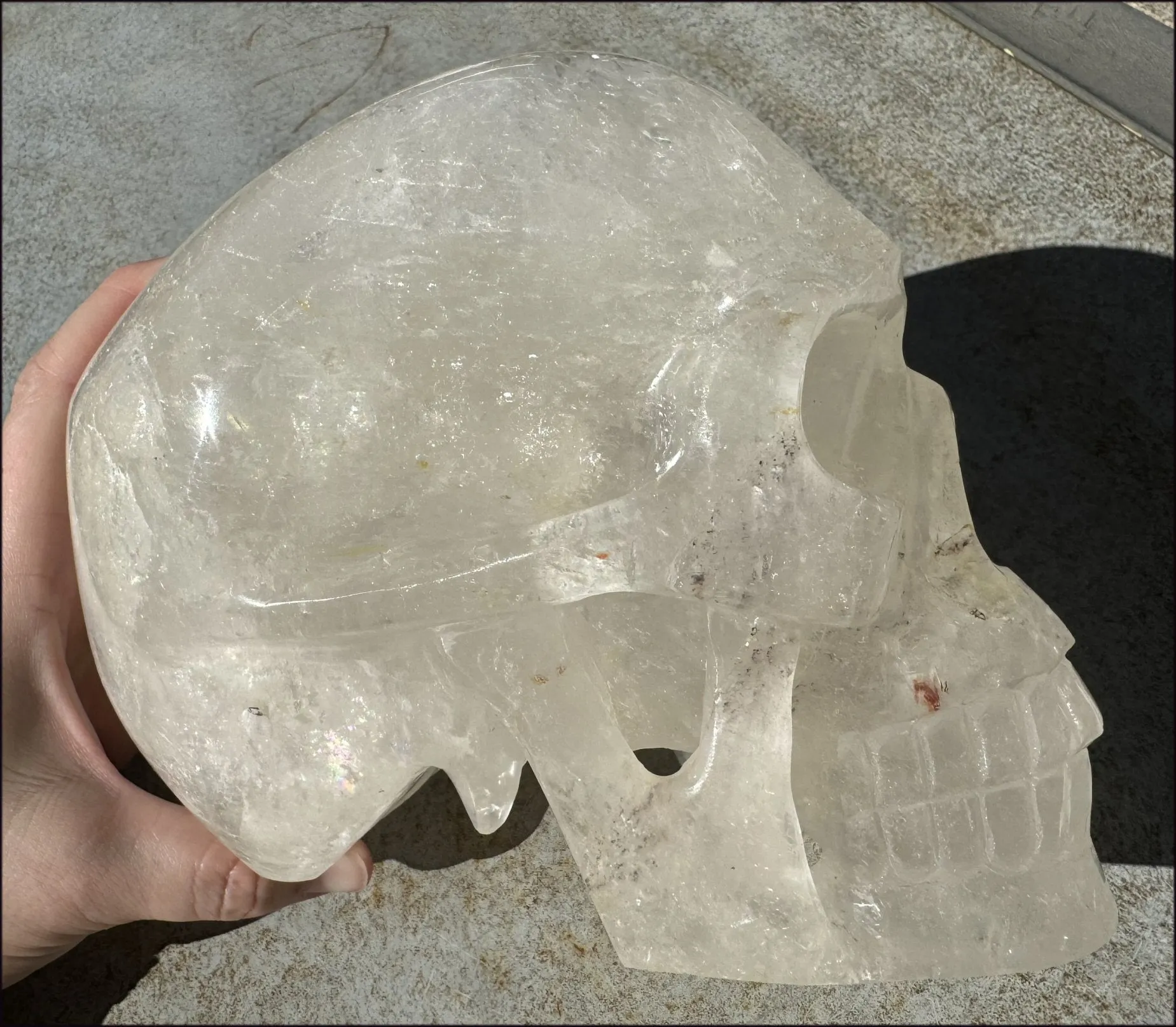 LifeSize Himalayan Quartz Crystal Skull with Crown Chakra Rainbows, Multi-Colored Hematite