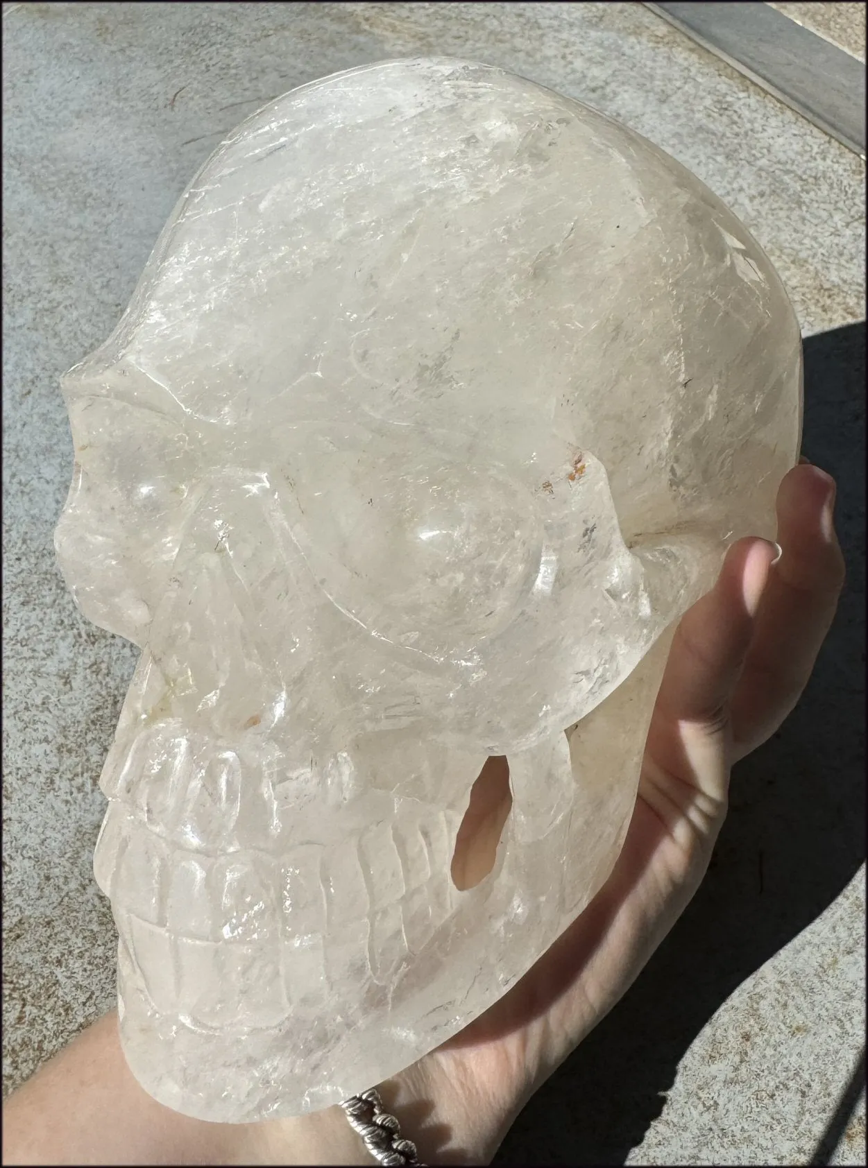 LifeSize Himalayan Quartz Crystal Skull with Crown Chakra Rainbows, Multi-Colored Hematite